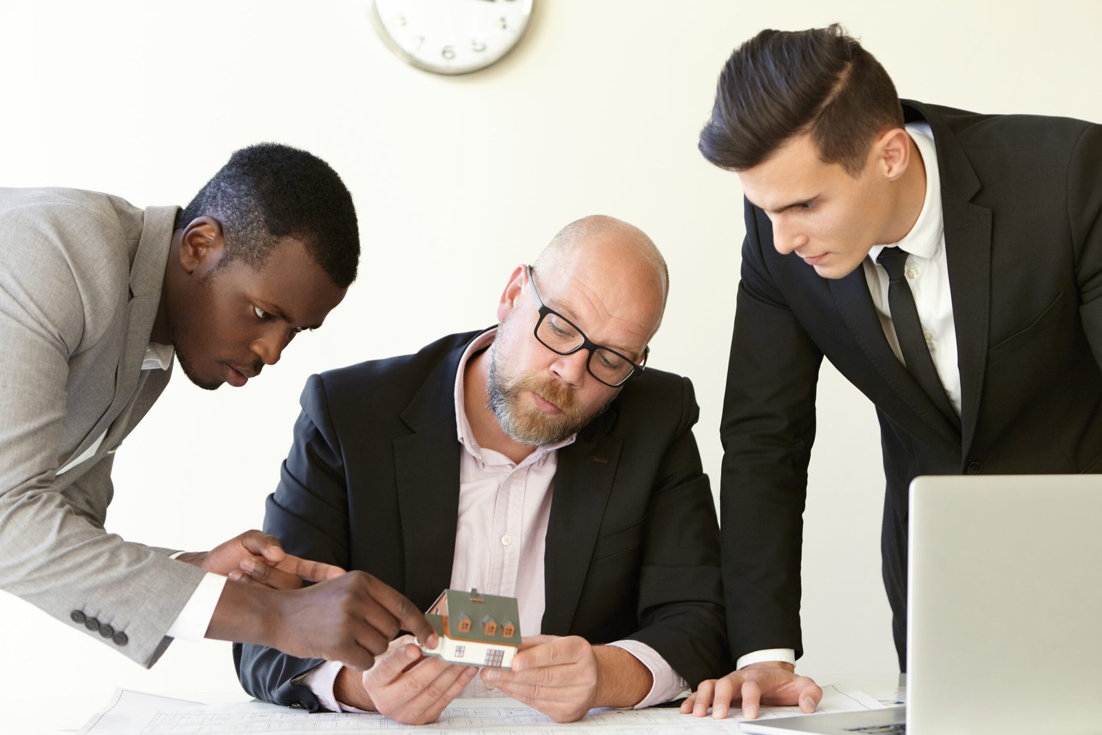 Team reviewing house model.